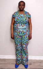 Plus size woman wearing a colorful patterned outfit against a plain background