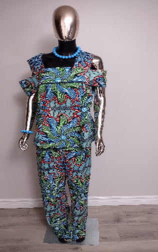 Mannequin wearing a colorful outfit with a patterned top and pants on a plain background