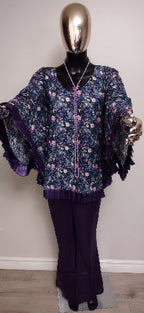 Mannequin wearing a floral blouse and dark pants against a plain background