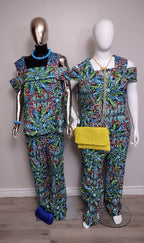 Two mannequins wearing matching colorful outfits with yellow clutch on a plain background